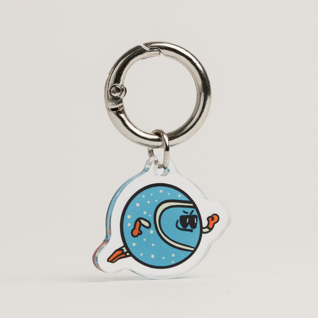 Fur Sie The Fetcher charm: A light blue acrylic dog accessory with white dots, featuring a character in sunglasses and orange gloves