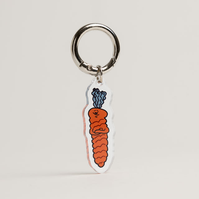 The Snob Fur Sie charm of carrot dog toy design on a gray background