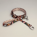 Fur Sie Clemens leash featuring an abstract earthy-toned pattern with a silver locking carabiner and signature logo charm