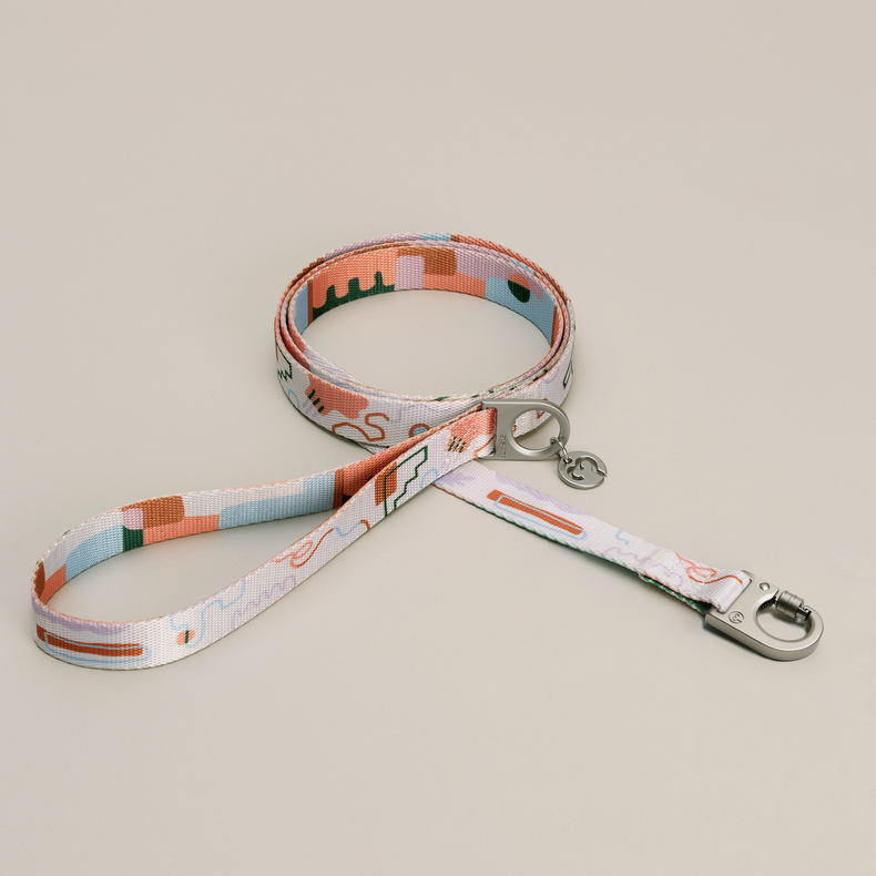 Fur Sie Matteo dog leash with soft pastels and abstract lines and metal hardware on a light gray background