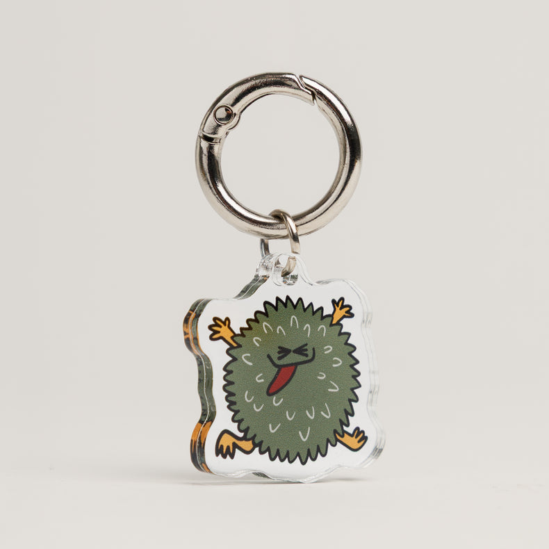 Fur Sie Troublemaker dog charm: Green acrylic accessory in a spiky chew toy shape with a mischievous character. On a silver metal clip