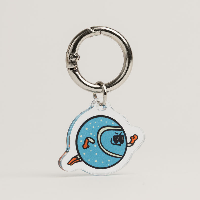 Fur Sie The Fetcher charm: A light blue acrylic dog accessory with white dots, featuring a character in sunglasses and orange gloves