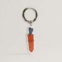 The Snob Fur Sie charm of carrot dog toy design on a gray background