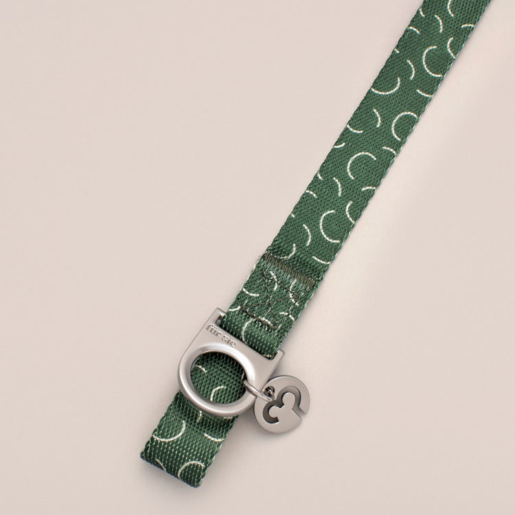 Close-up of the Fur Sie Sabine collar hardware showing the D-ring for leash attachment and the Fur Sie logo charm.