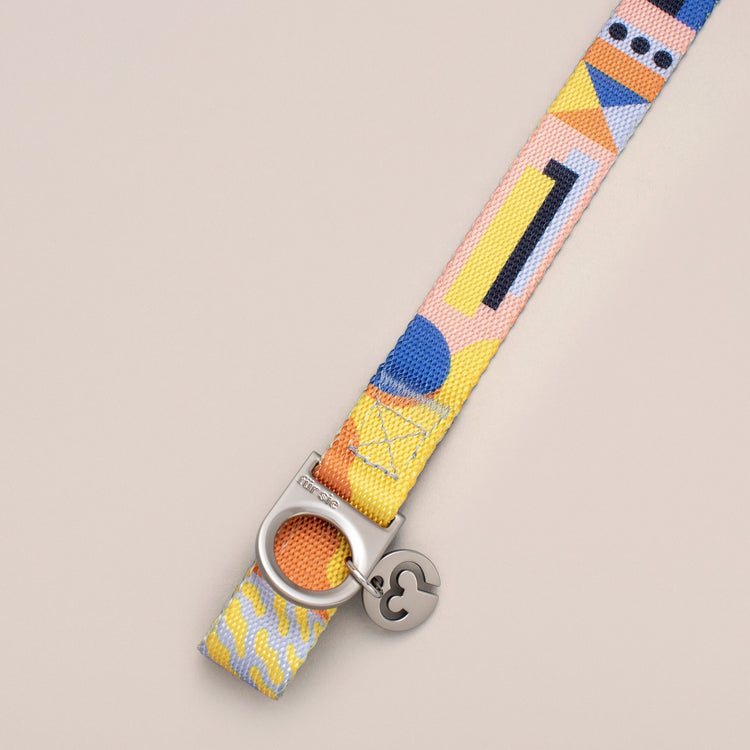 Close-up of the Fur Sie Una collar hardware showing the D-ring for leash attachment and the Fur Sie logo charm