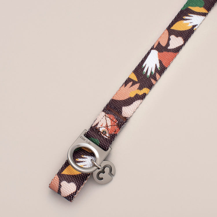 Close-up of the Fur Sie Clemens collar hardware showing the D-ring for leash attachment and the Fur Sie logo charm