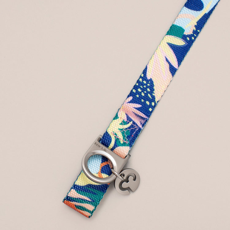 Close-up of the Fur Sie Frans collar hardware showing the D-ring for leash attachment and the Fur Sie logo charm