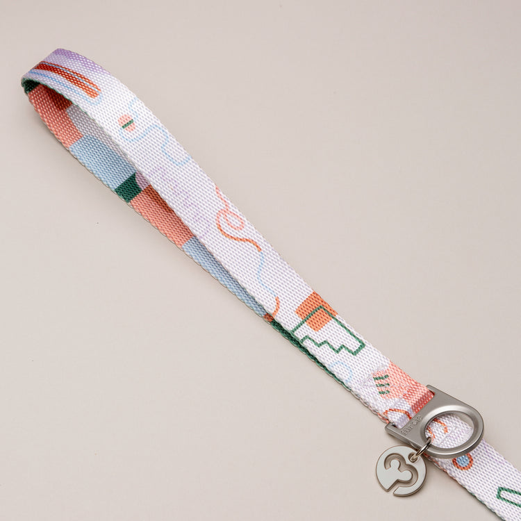 Matteo dog leash handle with soft pastel abstract pattern on a light neutral background